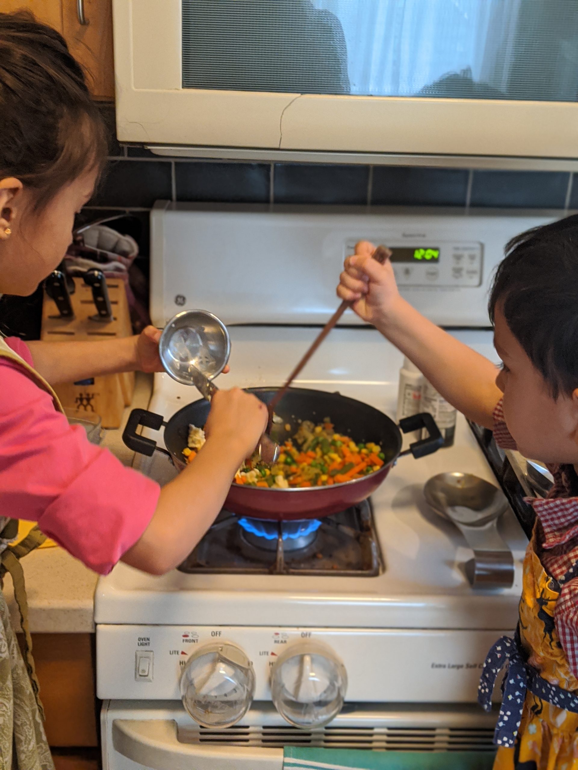 Children cooking on the stove