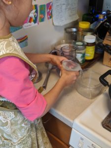 Child pouring liquid into a bowl