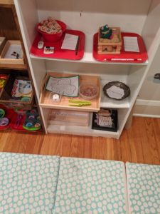 Neatly-arranged shelves with games and art supplies