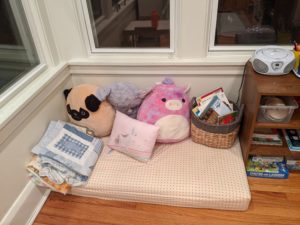 Pillows and stuffed animals on a small futon
