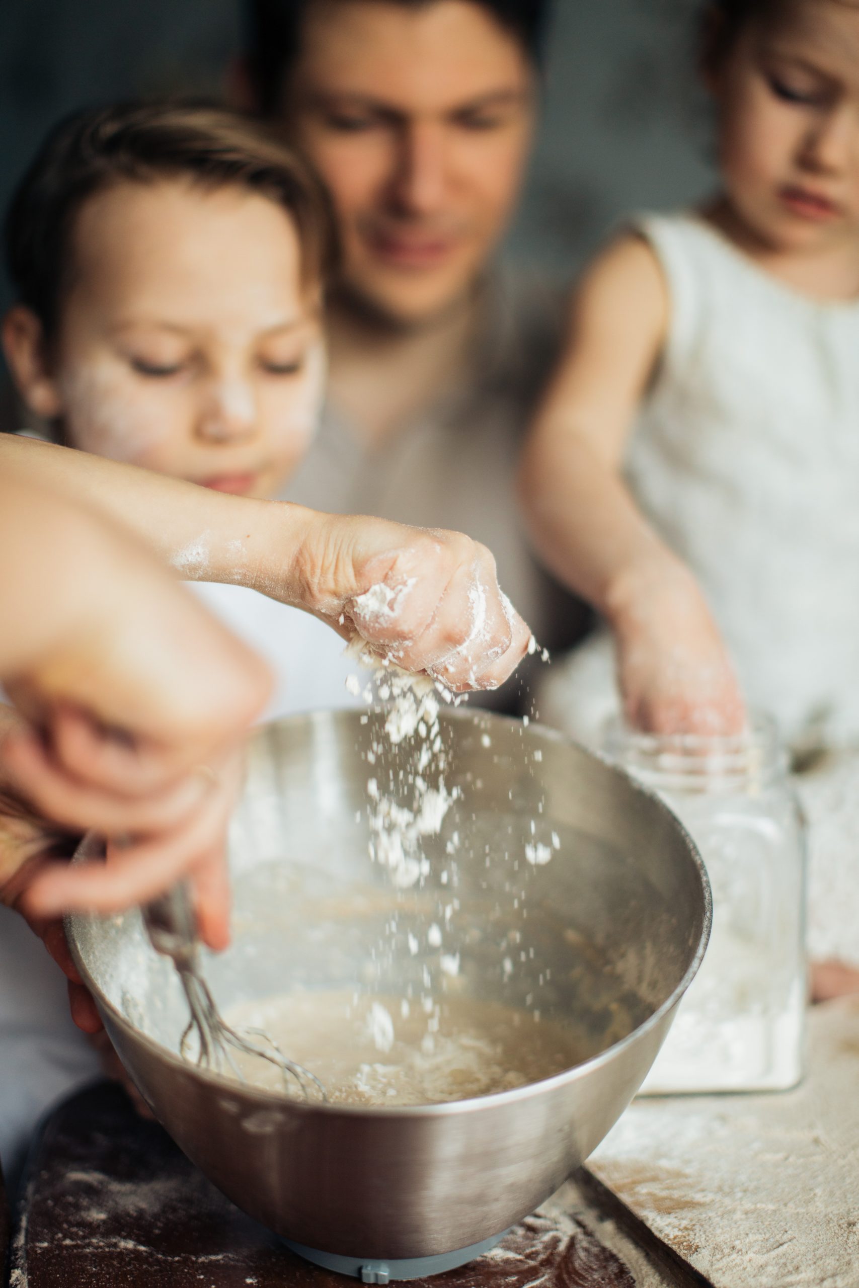 Mixing bowl and children helping to make dough