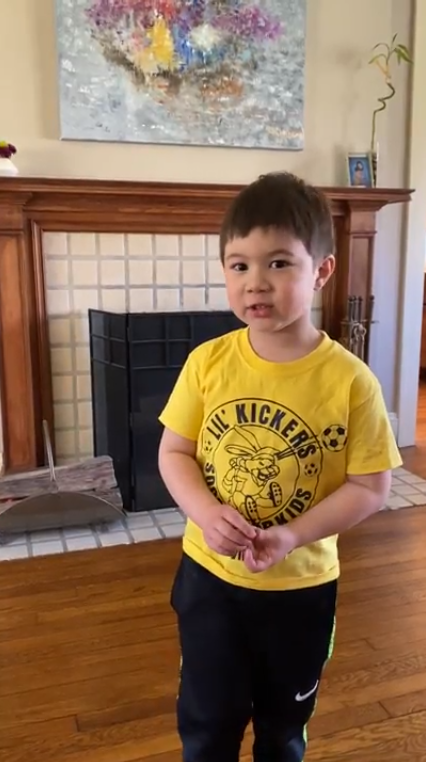 Oliver speaking in front of his fireplace at home