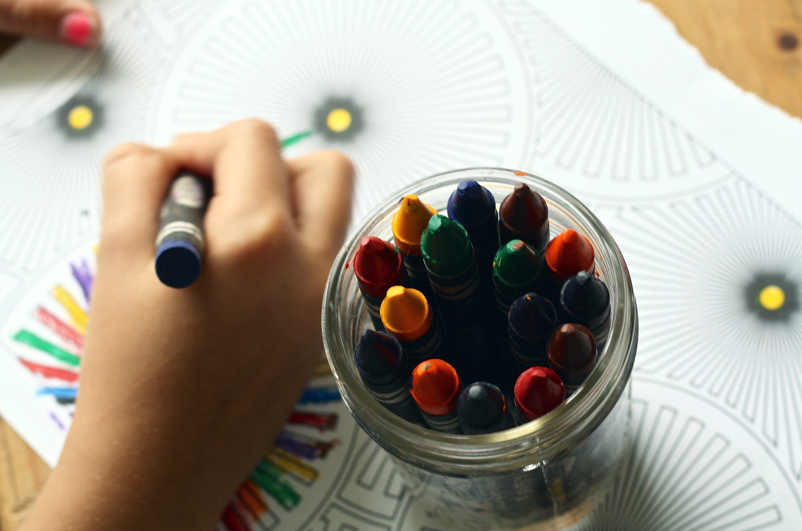 A child coloring an abstract design