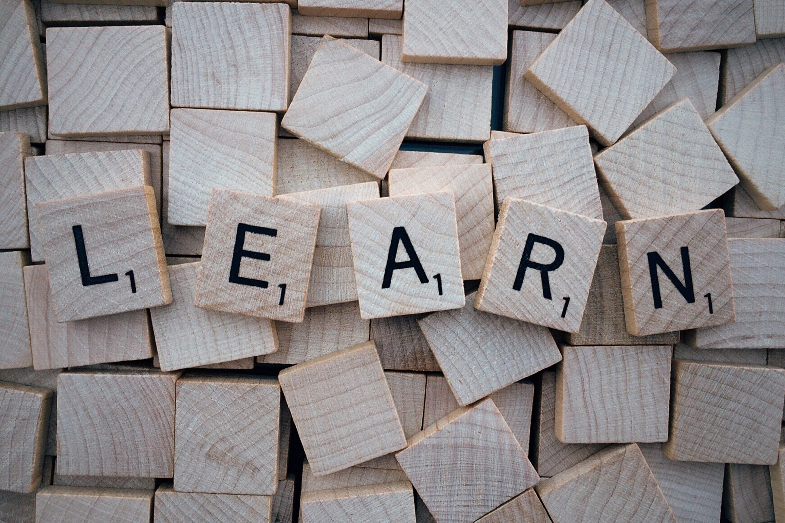 Scrabble tiles spelling out "LEARN"