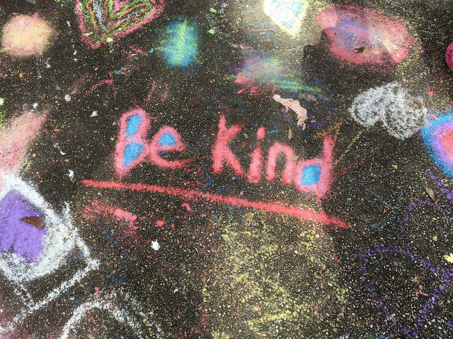 "Be kind" written in bright colors in chalk