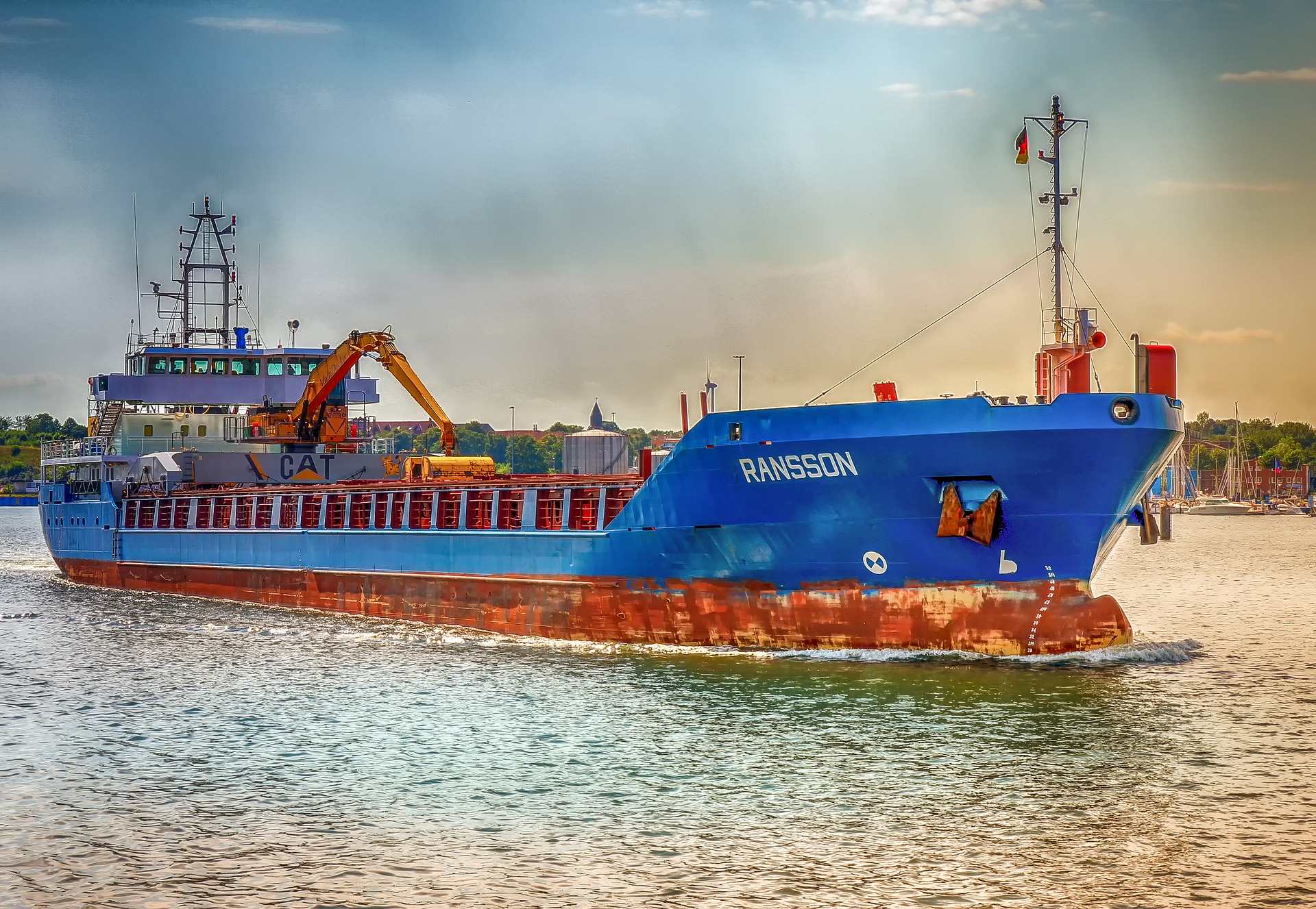 A blue and red freighter on the water